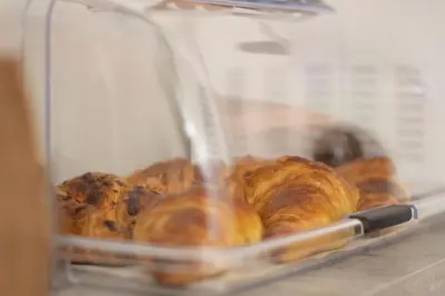 a bunch of croissants and other pastries in a machine at Capri B&B in Bolzano