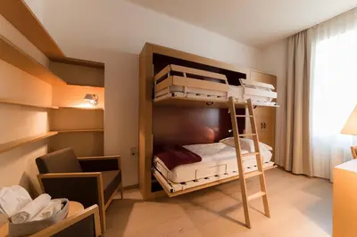 a small room with bunk beds in it at Hotel Stiegl Scala in Bolzano