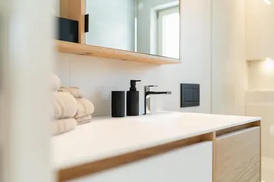 a bathroom with a sink with towels on a counter at VANEA - Alp Relax Guesthouse in Chienes