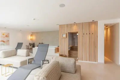 a living room with a pool and a table and chairs at VANEA - Alp Relax Guesthouse in Chienes