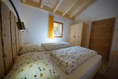 a bedroom with two beds and a window at Cresta in San Cassiano