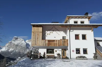 a house in the mountains with snow on the ground at Cresta in San Cassiano