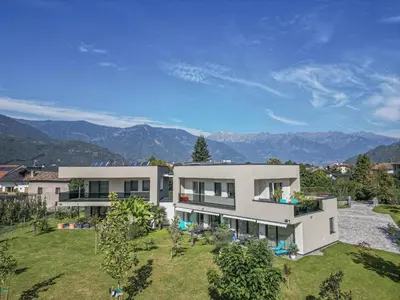 an aerial view of a house with mountains in the background at Garden Lodge in Gargazzone