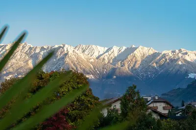 a view of a mountain range with snow covered mountains at Garden Lodge in Gargazzone