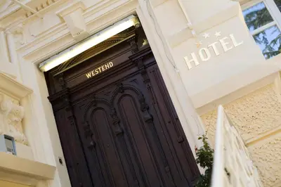 a wooden door to a hotel in a building at Hotel Villa Westend in Merano