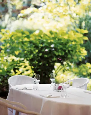 a white table with wine glasses on it at Hotel Greif, a Member of Design Hotels in Bolzano