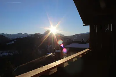 a view of the sun shining on a mountain at Lü de Terza in San Vigilio Di Marebbe