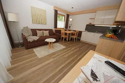 a living room with a couch and a table at Ciasa Wallis in Badia