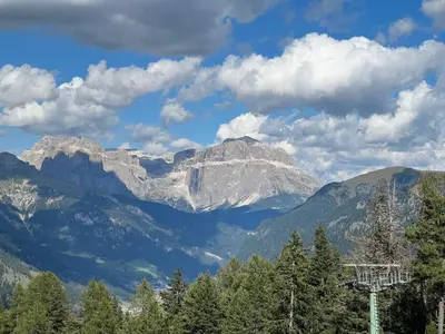 a view of a mountain range with trees and clouds at Mazzin Raggio di Sole in Campestrin