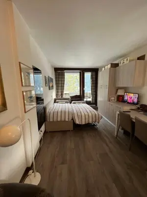 a bedroom with a bed and a desk in it at Mazzin Raggio di Sole in Campestrin