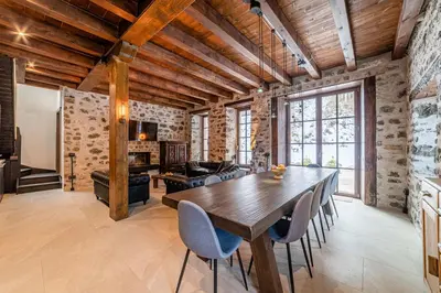 a large dining room with a wooden table and chairs at Villa Molin Del Faure in Alleghe