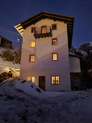 a building with a balcony on top of it in the snow at Villa Molin Del Faure in Alleghe