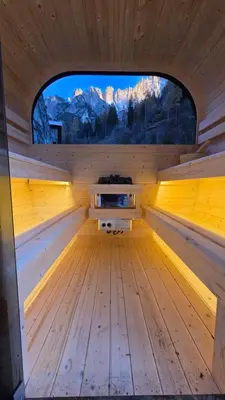 an empty wooden sauna with a large window at Villa Molin Del Faure in Alleghe