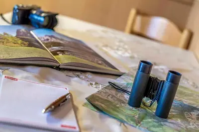 a table with an open book and an open book at Residence Villa al Sole in Selva di Val Gardena