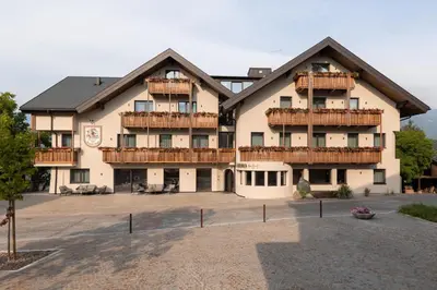 a large building with balconies on the front of it at Am Brunnen Apartments in Naz-Sciaves