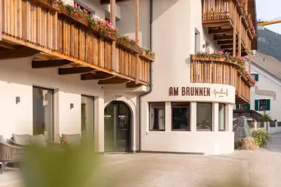 a building with a sign that reads ant brewery at Am Brunnen Apartments in Naz-Sciaves