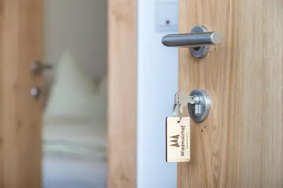 a lock on a door with a tag on it at Wiedmairhof in Villa Ottone