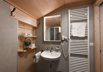 a bathroom with a sink and a mirror at Gasthof Jägerheim in Bressanone