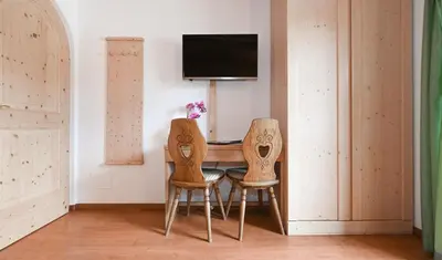 a dining room with a table and two chairs at Gasthof Jägerheim in Bressanone