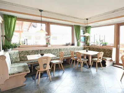 a restaurant with two tables and a couch at Gasthof Jägerheim in Bressanone