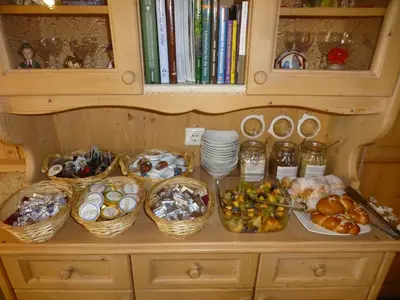 a table with baskets of food and other foods at Gasthof Jägerheim in Bressanone