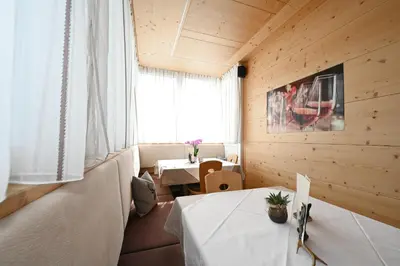 a dining room with two tables and a window at Gasthof Jägerheim in Bressanone