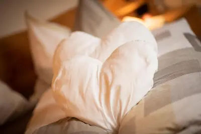 a close up of a book on a bed at Ferienwohnungen Kalchgruberhof in Ultimo