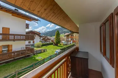 a balcony with a view of the mountains at Dimora al Vajolet in Pozza di Fassa