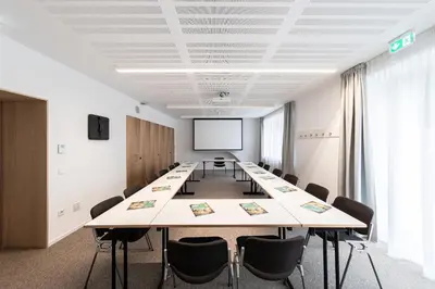 a conference room with a long table and chairs at Cusanus Akademie - Accademia Cusanus in Bressanone