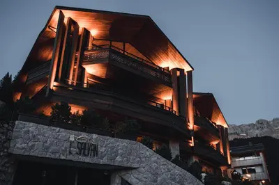 a building with lights on the side of it at Residence Chalet L'Salvan in Selva di Val Gardena