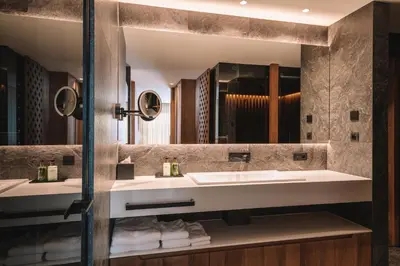 a bathroom with two sinks and a large mirror at Residence Chalet L'Salvan in Selva di Val Gardena
