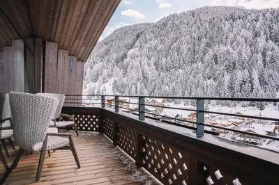 a balcony with chairs and a view of a mountain at Residence Chalet L'Salvan in Selva di Val Gardena