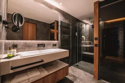 a bathroom with a sink and a shower at Residence Chalet L'Salvan in Selva di Val Gardena