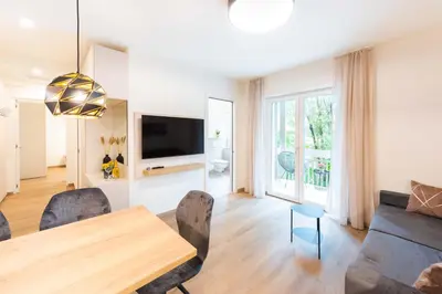 a living room with a table and a couch at CityPointApartments-Park in Merano
