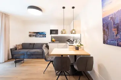 a living room with a table and a couch at CityPointApartments-Park in Merano
