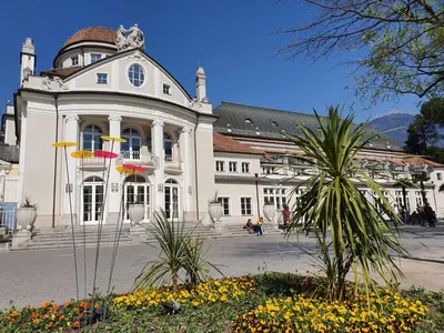 a large white building with flowers in front of it at CityPointApartments-Park in Merano