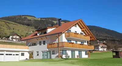 a large white house with a brown roof at Stiflerhof in Falzes