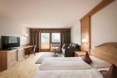 a hotel room with a bed and a television at Hotel Onach in San Lorenzo di Sebato