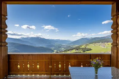 a room with a table and a view of mountains at Pitznerhof in Maranza