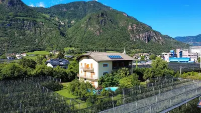a house with a mountain in the background at Gasserhof Bozen in Bolzano