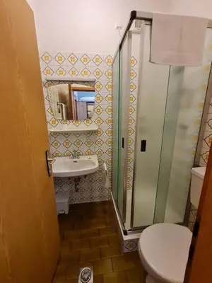 a bathroom with a shower and a toilet and a sink at Gasserhof Bozen in Bolzano