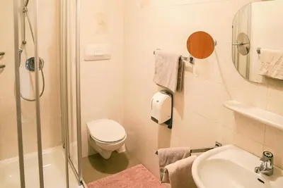a bathroom with a toilet and a sink and a shower at Appartements Residence Ganthaler in Rablà