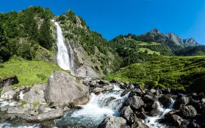 a waterfall on the side of a mountain at Appartements Residence Ganthaler in Rablà