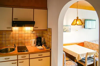 a small kitchen with a sink and a table at Appartements Residence Ganthaler in Rablà