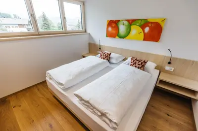 two beds in a room with a painting on the wall at Lisis Loggia in Nova Ponente