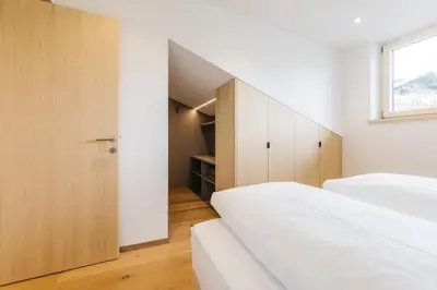 a bedroom with two beds and a staircase at Lisis Loggia in Nova Ponente