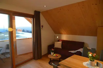 a living room with a couch and a table at Lobishof in Soprabolzano
