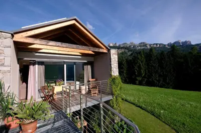 a house with a balcony with a view at Fior Tamion in Vigo di Fassa