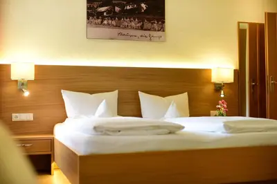 a bedroom with a large bed with white pillows at Ansitz Gamp in Chiusa