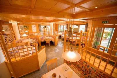 an overhead view of a restaurant with tables and chairs at Hotel Garni Doris in Castelrotto